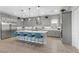 Spacious kitchen features a large island, stainless steel appliances, pendant lighting and stylish counter seating at 7277 W Landberg Ave, Las Vegas, NV 89178