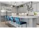 Modern kitchen with a sleek island, stainless steel appliances, and stylish seating at 7277 W Landberg Ave, Las Vegas, NV 89178