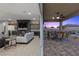 Modern living room and covered patio boasts open design, indoor/outdoor living, and a cozy fireplace at 7277 W Landberg Ave, Las Vegas, NV 89178