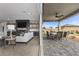 Living room with fireplace and sliding glass doors connecting to an outdoor dining area at 7277 W Landberg Ave, Las Vegas, NV 89178