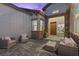 Inviting outdoor patio with comfortable seating and a stylish stone wall at 7277 W Landberg Ave, Las Vegas, NV 89178