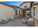 Inviting outdoor patio with comfortable seating and a stylish stone wall at 7277 W Landberg Ave, Las Vegas, NV 89178