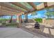Cozy backyard features a covered patio, fire pit, and putting green at 7368 Mission Hills Dr, Las Vegas, NV 89113