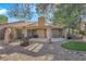 Landscaped backyard offers a covered patio area with fire pit and putting green at 7368 Mission Hills Dr, Las Vegas, NV 89113