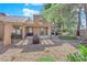 Expansive backyard features a putting green, fire pit, and mature landscaping at 7368 Mission Hills Dr, Las Vegas, NV 89113