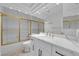Modern bathroom features elegant vanity with marble countertops and gold shower at 7368 Mission Hills Dr, Las Vegas, NV 89113