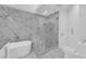 Elegant bathroom featuring a soaking tub next to a glass-enclosed walk-in shower at 7368 Mission Hills Dr, Las Vegas, NV 89113