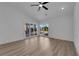 Spacious bedroom with wood floors, ceiling fan, recessed lighting, and a glass sliding door leading to the backyard at 7368 Mission Hills Dr, Las Vegas, NV 89113