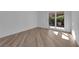 Minimalist bedroom with wood-style floors and French doors leading to the outdoors at 7368 Mission Hills Dr, Las Vegas, NV 89113