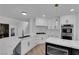 Bright kitchen features white cabinets, stainless steel appliances, and quartz countertops at 7368 Mission Hills Dr, Las Vegas, NV 89113
