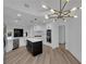Bright open kitchen with quartz counters, island, white cabinetry, and stainless steel appliances at 7368 Mission Hills Dr, Las Vegas, NV 89113