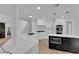 Bright kitchen featuring a quartz countertop, an island with a microwave, and white cabinetry at 7368 Mission Hills Dr, Las Vegas, NV 89113