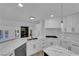 Modern kitchen features marble counters, stainless appliances, and white cabinetry, offering a sleek and stylish space at 7368 Mission Hills Dr, Las Vegas, NV 89113