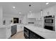 Updated kitchen boasts stainless appliances, a marble countertop island, and white cabinetry, perfect for modern living at 7368 Mission Hills Dr, Las Vegas, NV 89113