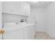 Bright laundry room with modern washer and dryer, plus ample storage at 7368 Mission Hills Dr, Las Vegas, NV 89113