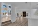 Bright open-plan living room with fireplace, large windows, and wood floors at 7368 Mission Hills Dr, Las Vegas, NV 89113