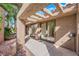 Covered patio area with tile flooring and views of the landscaped garden at 7368 Mission Hills Dr, Las Vegas, NV 89113
