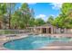 Community pool area with lounge chairs and landscaped surroundings at 7368 Mission Hills Dr, Las Vegas, NV 89113