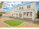 Expansive backyard with well-maintained grass, covered patio, and lush landscaping at 7464 Forestdale Ct, Las Vegas, NV 89120