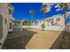 Large backyard with a covered patio and desert landscaping with green grass at 7464 Forestdale Ct, Las Vegas, NV 89120