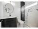 Modern bathroom featuring decorative tile, dark cabinets, updated sink, and glass shower doors at 7464 Forestdale Ct, Las Vegas, NV 89120