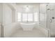 Bright, spacious bathroom featuring a modern soaking tub, separate shower, and stylish fixtures at 7464 Forestdale Ct, Las Vegas, NV 89120