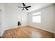 Spacious bedroom featuring wood floors, a ceiling fan, and a walk-in closet through the ensuite bathroom at 7464 Forestdale Ct, Las Vegas, NV 89120