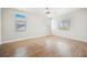 Expansive bedroom featuring hardwood floors and multiple windows for natural light at 7464 Forestdale Ct, Las Vegas, NV 89120