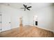 Bright bedroom with wood flooring, ceiling fan, and ensuite bathroom and walk-in closet at 7464 Forestdale Ct, Las Vegas, NV 89120