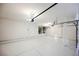 Spacious garage with white walls, epoxy flooring, and overhead storage racks at 7464 Forestdale Ct, Las Vegas, NV 89120