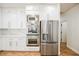 Modern kitchen featuring stainless steel appliances and white cabinets and quartz countertops at 7464 Forestdale Ct, Las Vegas, NV 89120