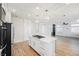 Open kitchen featuring white cabinets, a center island with gas cooktop, and stainless steel appliances at 7464 Forestdale Ct, Las Vegas, NV 89120