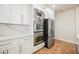 Modern kitchen boasts stainless steel appliances including microwave, double oven, and refrigerator at 7464 Forestdale Ct, Las Vegas, NV 89120