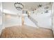 Open-concept living area with wood-look floors, second story balcony, and high ceilings at 7464 Forestdale Ct, Las Vegas, NV 89120