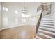 Bright living room featuring a staircase, high ceilings, and wood-look flooring at 7464 Forestdale Ct, Las Vegas, NV 89120