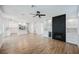 View of the living room into the kitchen, boasting an open layout and sleek fireplace at 7464 Forestdale Ct, Las Vegas, NV 89120