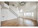 Spacious living room with tall ceilings, wood floors, staircase and many bright windows at 7464 Forestdale Ct, Las Vegas, NV 89120