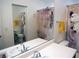 Bright bathroom with dual sinks, large vanity mirror, and decorative shower curtain at 7665 Calico Fields St, Las Vegas, NV 89149