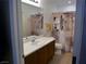 Clean bathroom with a large vanity mirror and decorative shower curtain at 7665 Calico Fields St, Las Vegas, NV 89149