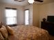 Relaxing bedroom with ceiling fan, natural light, and private patio access at 7665 Calico Fields St, Las Vegas, NV 89149