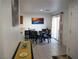 Bright dining area with a round table, stylish chairs, and sliding glass doors to the patio at 7665 Calico Fields St, Las Vegas, NV 89149