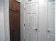 Hallway with pantry, neutral walls, and white doors with metal hardware at 7665 Calico Fields St, Las Vegas, NV 89149