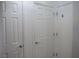 Hallway with a neutral palette, bright white doors, and silver hardware at 7665 Calico Fields St, Las Vegas, NV 89149