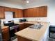 Well-equipped kitchen with wooden cabinets, stainless steel appliances, and ample counter space for cooking at 7665 Calico Fields St, Las Vegas, NV 89149