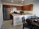 Functional kitchen with stainless steel appliances, wooden cabinets, and a breakfast bar for casual dining at 7665 Calico Fields St, Las Vegas, NV 89149