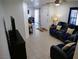 Spacious living area showcasing modern decor, comfortable seating, and tiled flooring at 7665 Calico Fields St, Las Vegas, NV 89149