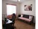 Functional office space with a modern desk, comfortable seating, and calming decor at 7665 Calico Fields St, Las Vegas, NV 89149