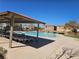 Community swimming pool with lounge chairs, sunshade, and a clear blue pool provides a refreshing retreat for residents at 7665 Calico Fields St, Las Vegas, NV 89149