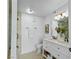 Bright bathroom featuring a double vanity with granite countertops, modern lighting, and a glass door shower at 7904 Fossil Creek Ln # 101, Las Vegas, NV 89145