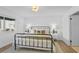 Bright bedroom showcases a comfortable iron bed frame, fresh paint and vinyl floors at 7904 Fossil Creek Ln # 101, Las Vegas, NV 89145